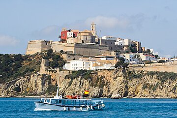 A boat in front of the old town of ibiza