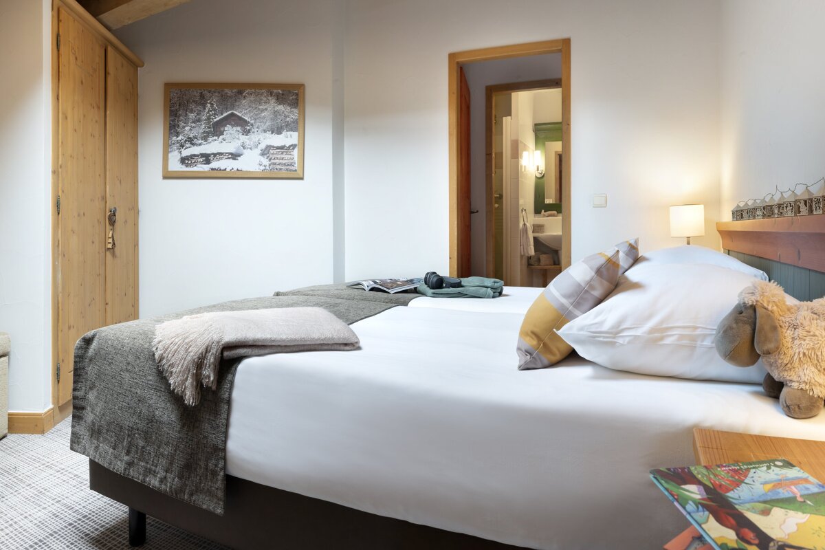 A bedroom with a bed and a picture on the wall