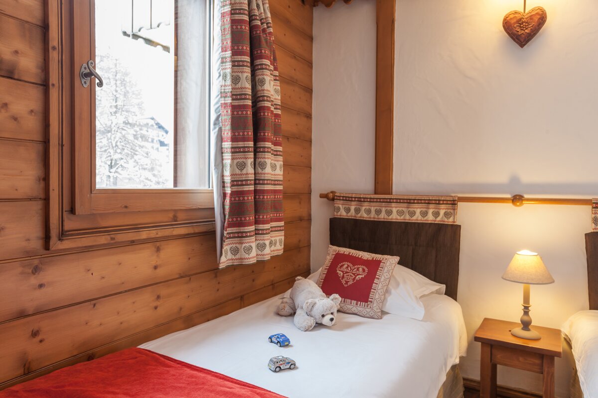 A bed with a pillow that says ' amour ' on it