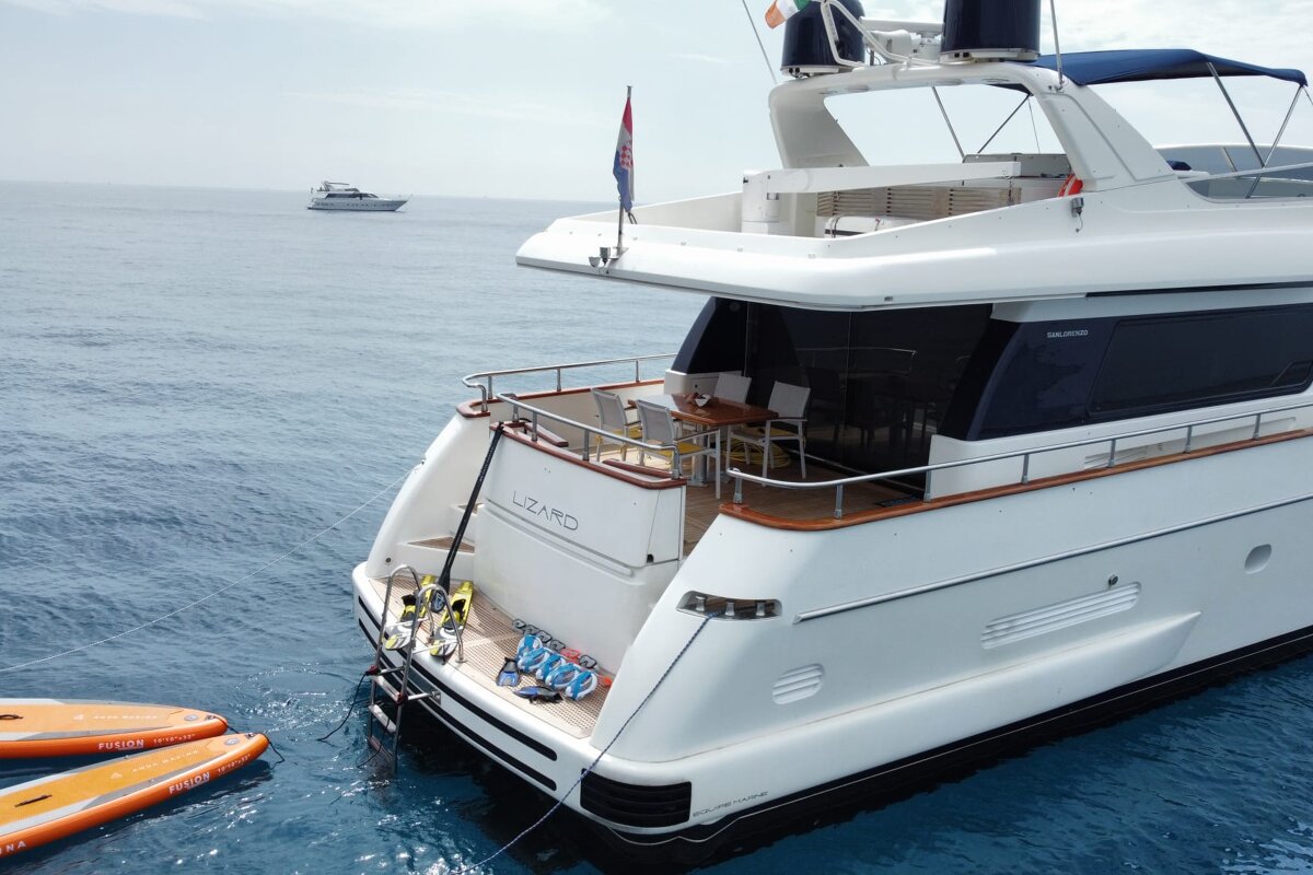 A large white yacht with the name lizard on the side