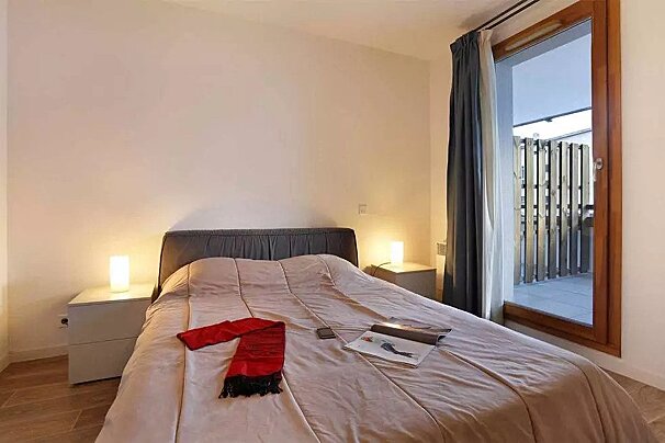 A bedroom with a bed and a magazine on it