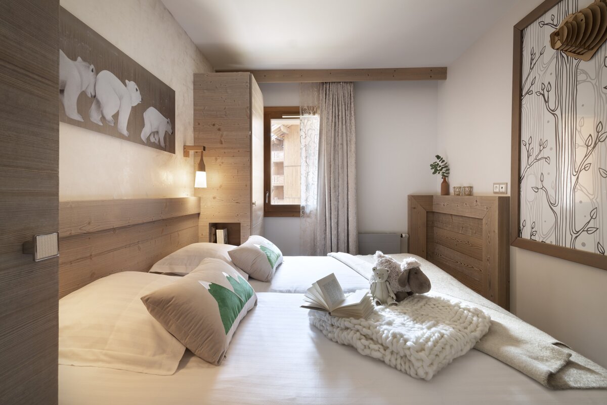 A bedroom with two beds and a picture of polar bears on the wall