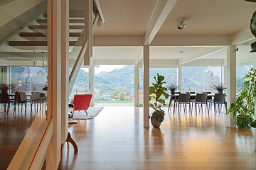 A house with a lot of windows and a red chair