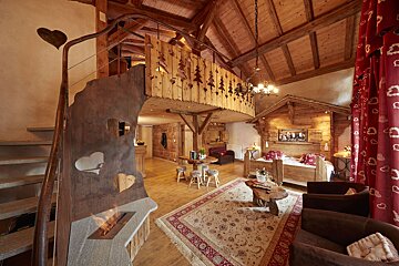 A living room with a fireplace and a bed