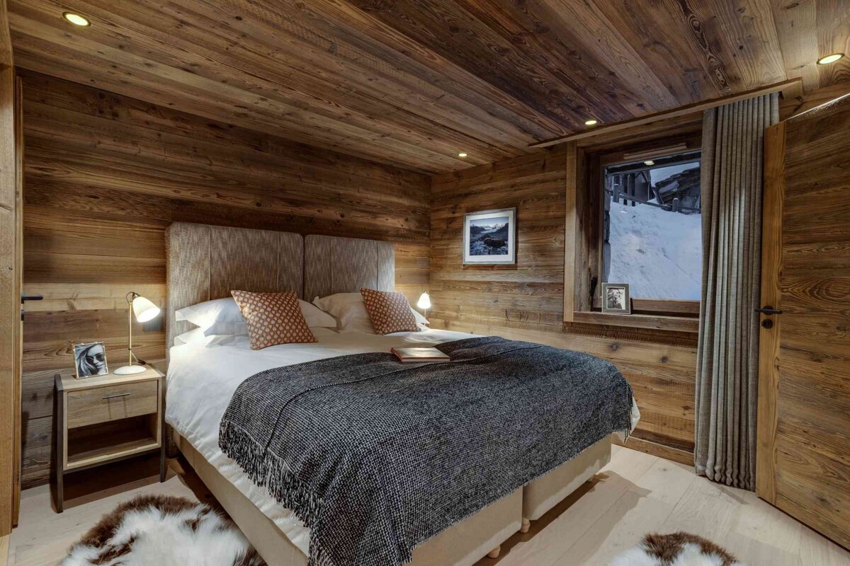 A bedroom with a large bed and a window