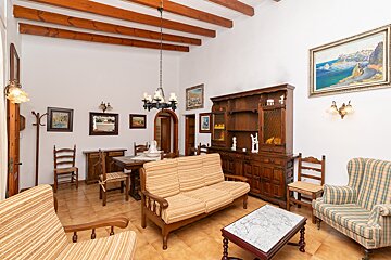 A living room with a couch a chair and a table