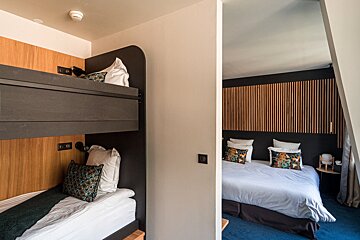 A bedroom with a bunk bed and a large bed