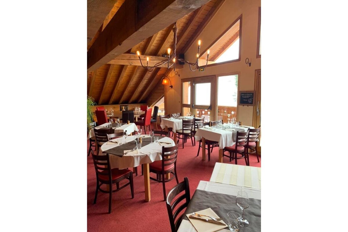 A restaurant with tables and chairs and a sign that says restaurant