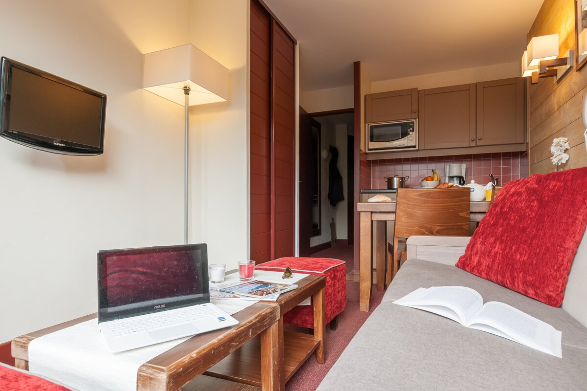 A living room with an asus laptop on a table