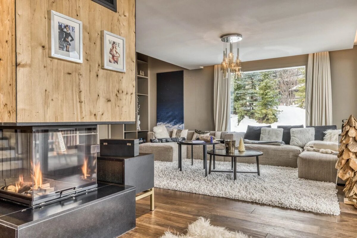 A living room with a fireplace and a picture on the wall that says vogue