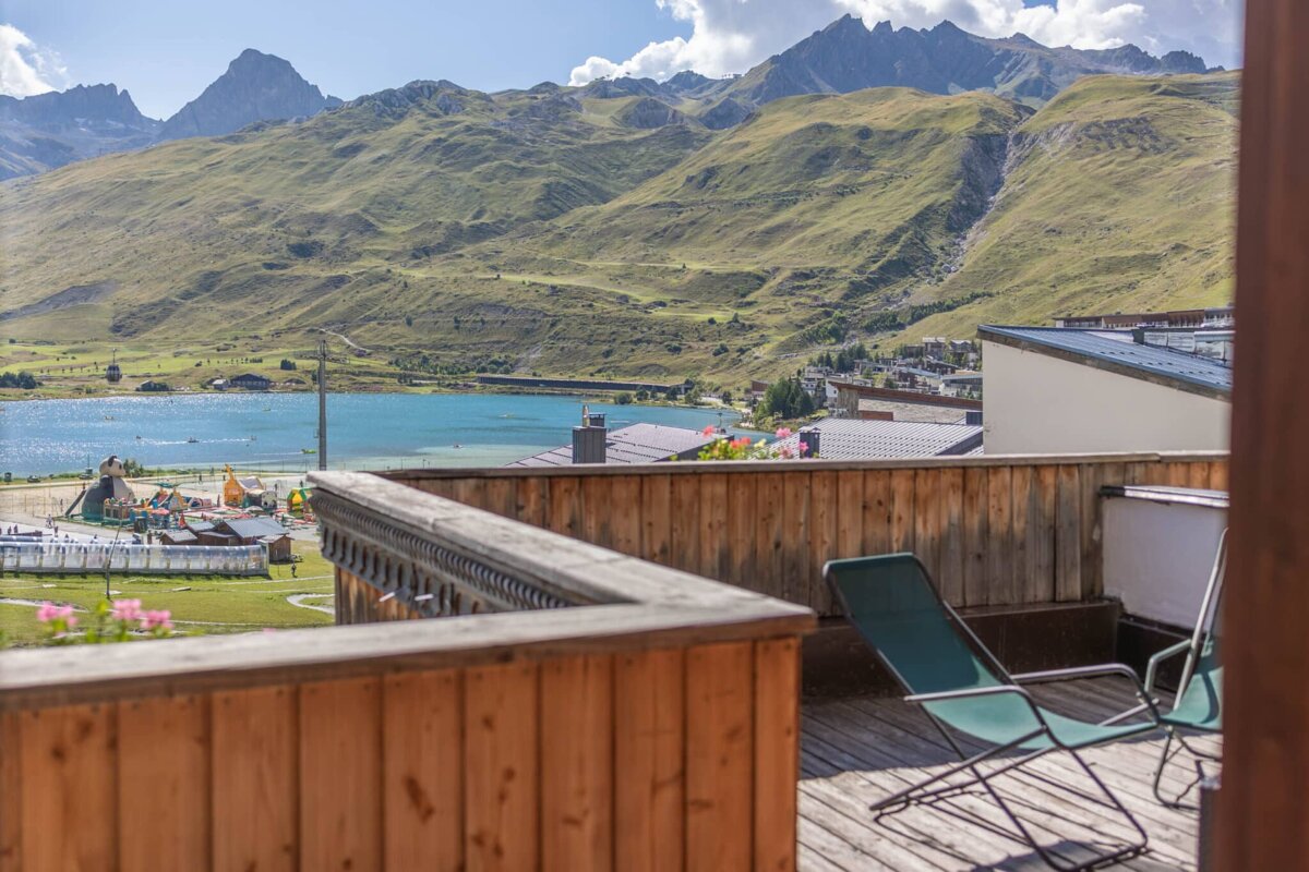 A view of mountains and a lake from a balcony