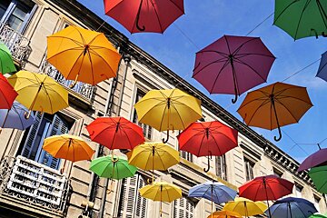 colourful umbrellas in the streets of st foy la grande