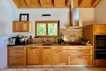 A kitchen with wooden cabinets and granite counter tops