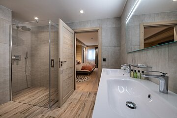 A bathroom with a sink and a walk in shower