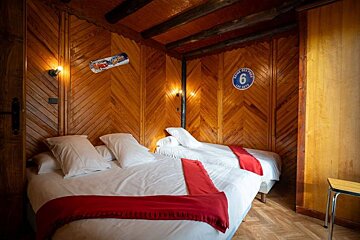 A bedroom with two beds and a sign that says