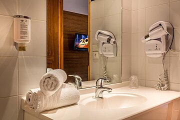 A bathroom with a bottle of dove shampoo on the wall