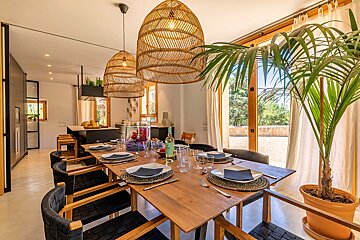A dining room table with plates and utensils on it