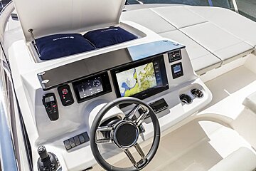 The steering wheel of a boat has a map on it