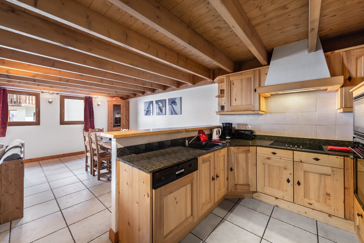 A kitchen with wooden cabinets and granite counter tops