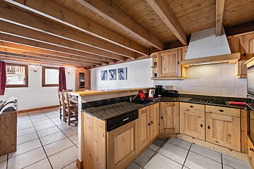 A kitchen with wooden cabinets and granite counter tops