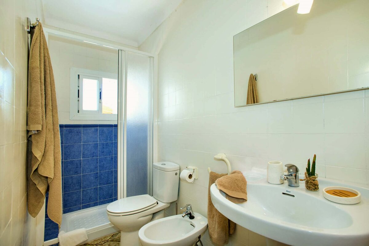 A bathroom with a toilet a bidet and a sink