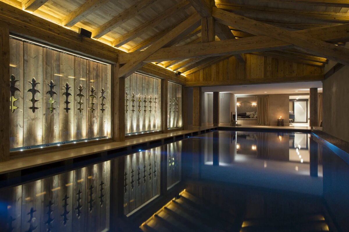 A large indoor swimming pool with a wooden ceiling