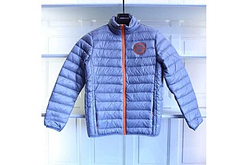 A grey padded jacket with an orange trim is hanging on a hanger