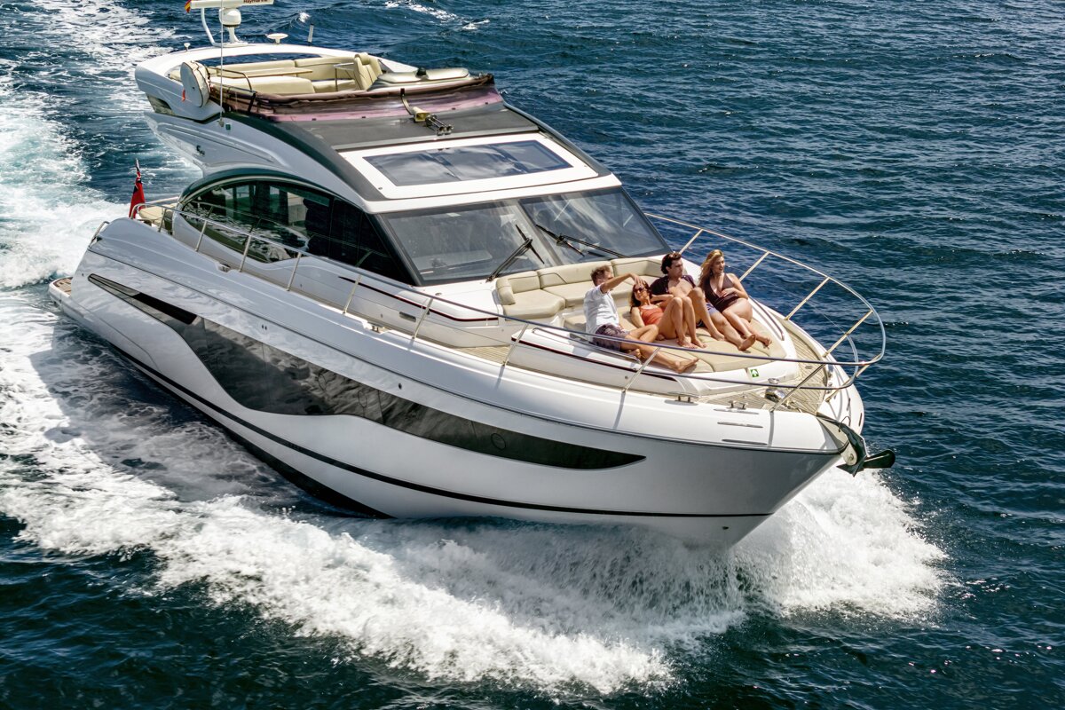 A group of people are sitting on a boat in the ocean