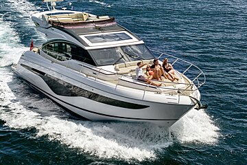 A group of people are sitting on a boat in the ocean