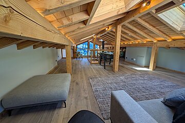 A living room with wooden beams and a couch