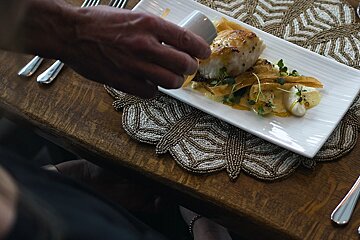 A plate of food on a table with a beaded place mat