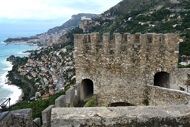 A view of a city from the top of a cliff overlooking the ocean