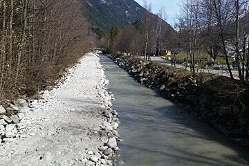 a river with debris piled up on one side