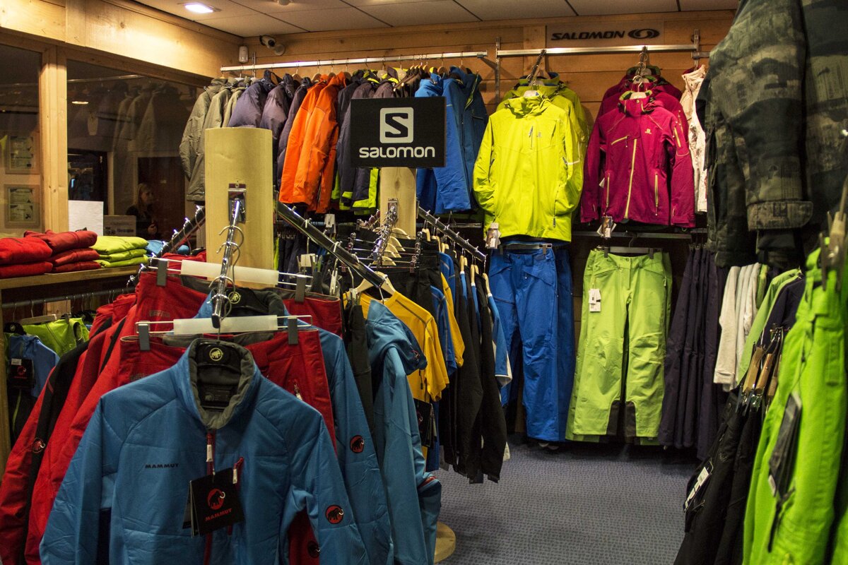 A salomon sign hangs above a rack of clothes