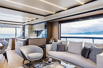 A living room with a couch a chair and a coffee table with a book on it that says