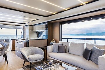 A living room with a couch a chair and a coffee table with a book on it that says 