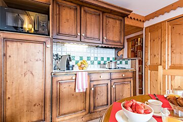 A kitchen with wooden cabinets and a microwave that says ' siemens ' on it