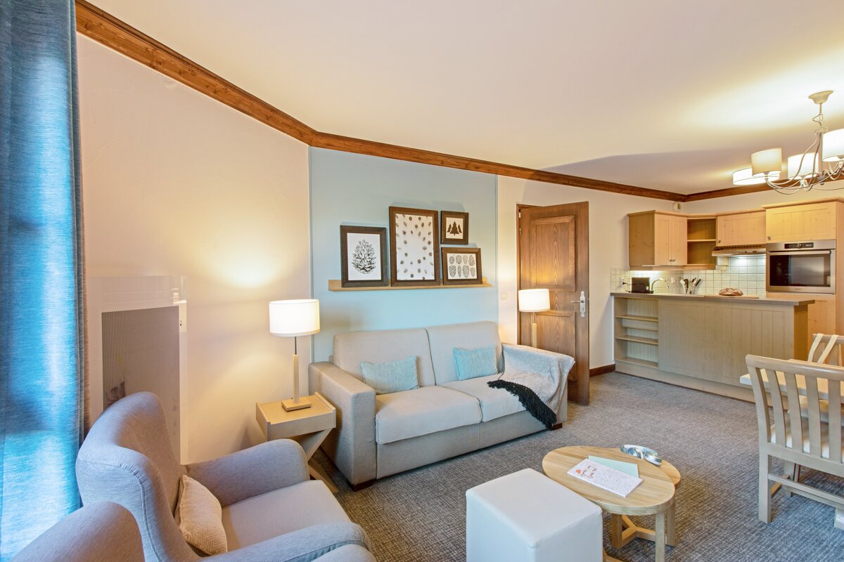 A living room with a couch a chair and a table