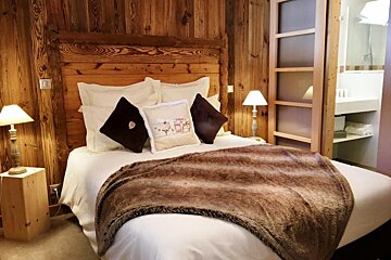 A bed with a pillow that says sheep on it