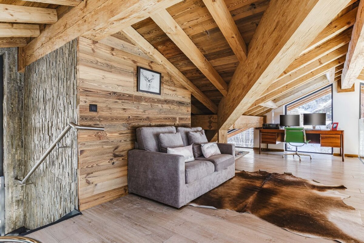 A living room with a couch and a desk
