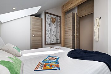 Two children 's books are on a bed in a bedroom