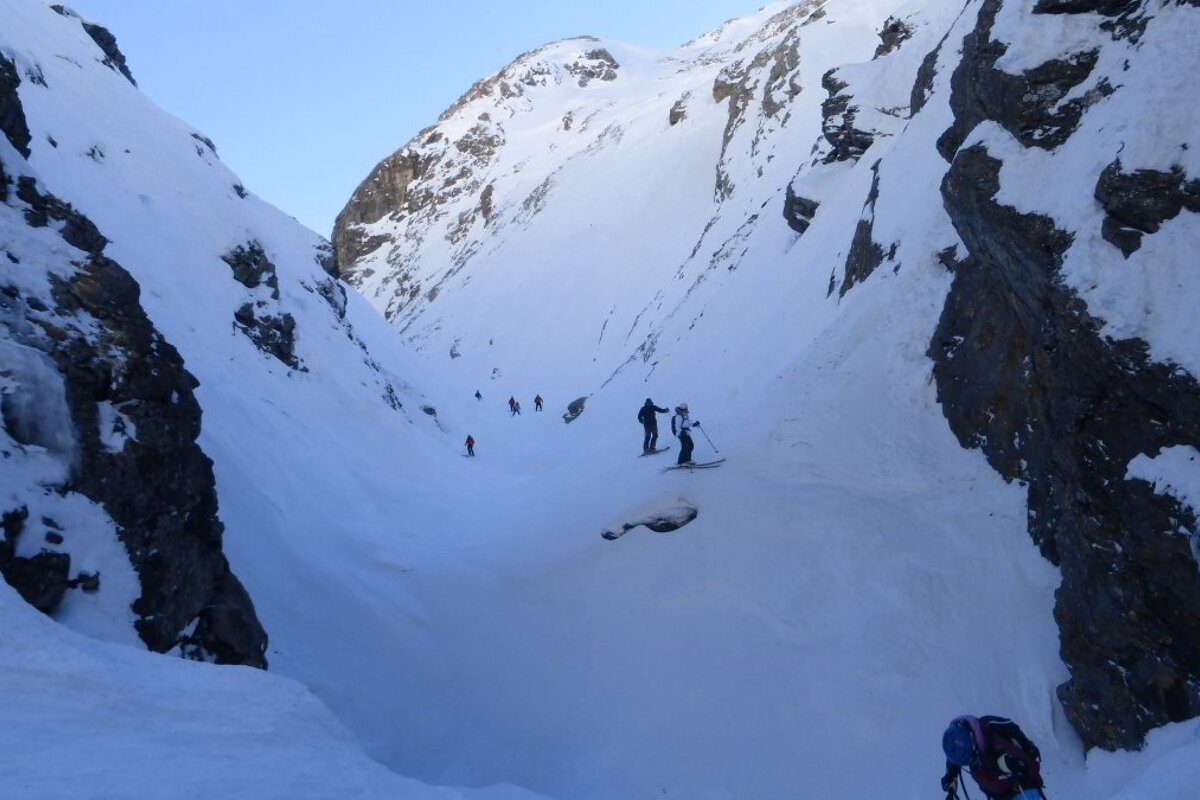 skiers in a gully
