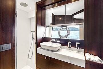 A bathroom with a sink a mirror and a window