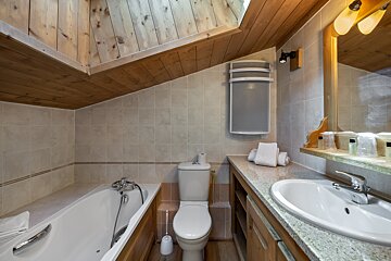 A bathroom with a bathtub toilet and sink