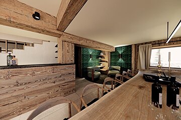 Warm, rustic chalet interior features a wooden bar, a cozy lounge with green walls, and a large timber table near a window with candles.
