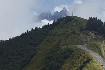mountain peaks appearing through the clouds