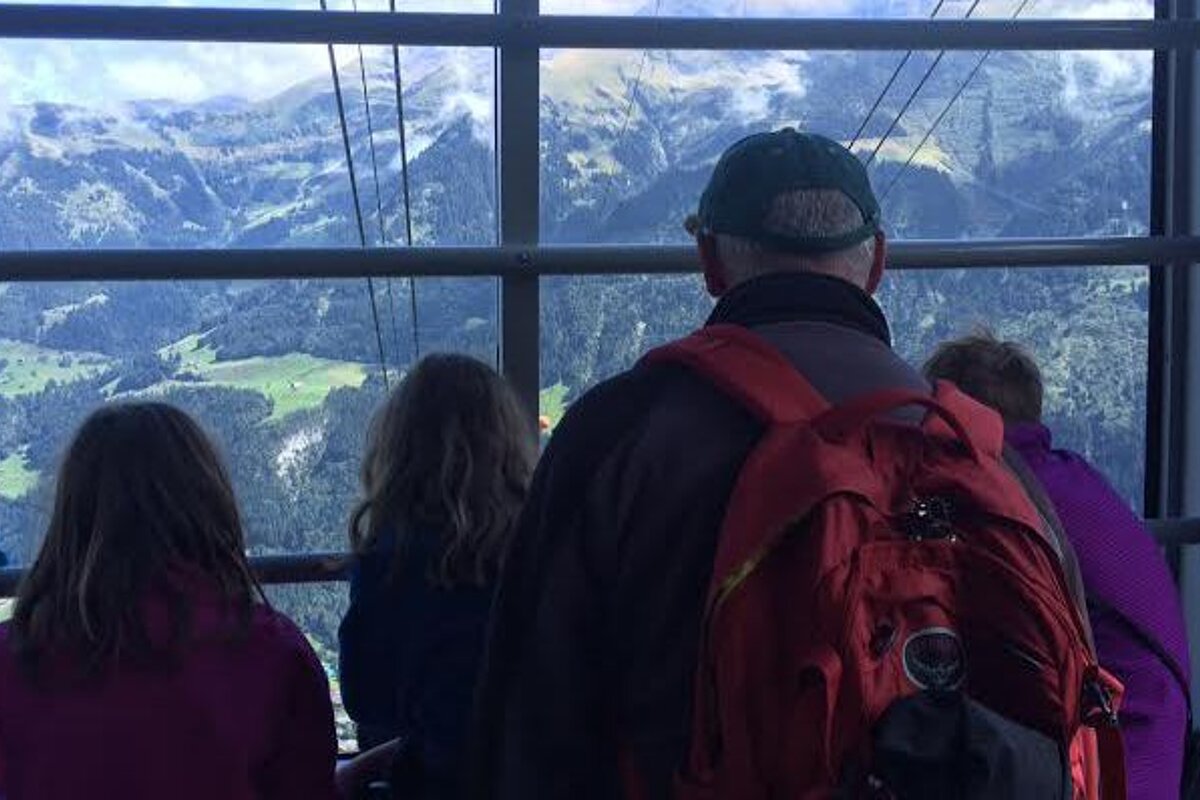 peopl in a cable car looking through the window