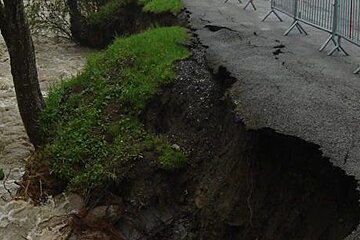 a river bank by a road in morzine that collapsed