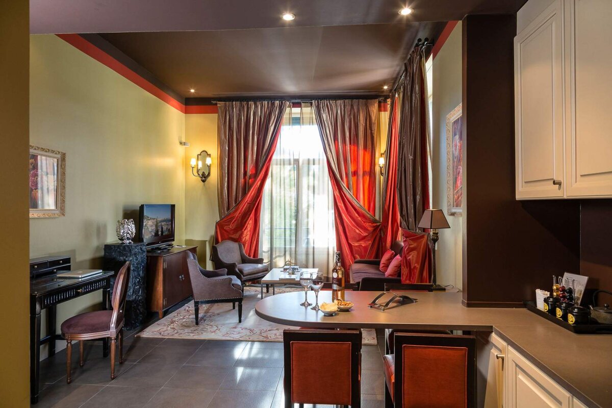 A living room with red curtains and a flat screen tv