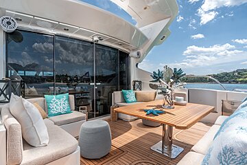 A boat has a table with a vase of flowers on it